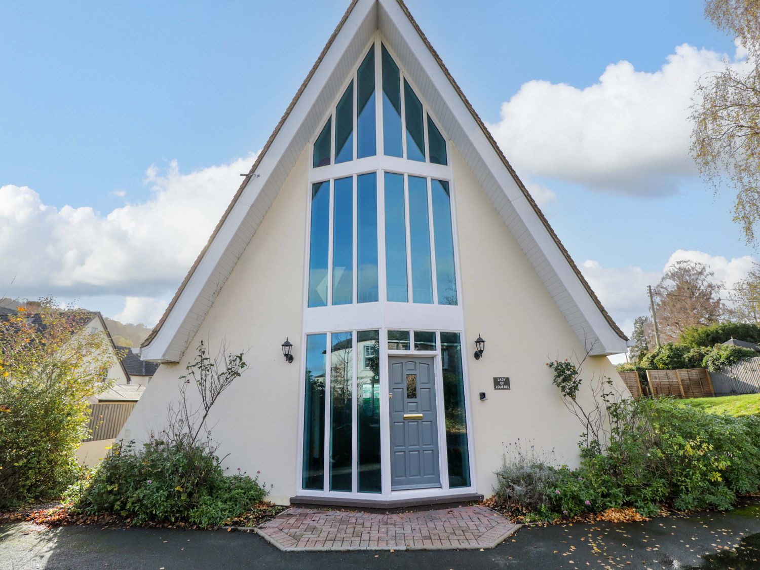 A house entrance with large windows at Lady Of Lourdes in Whitchurch, Herefordshire