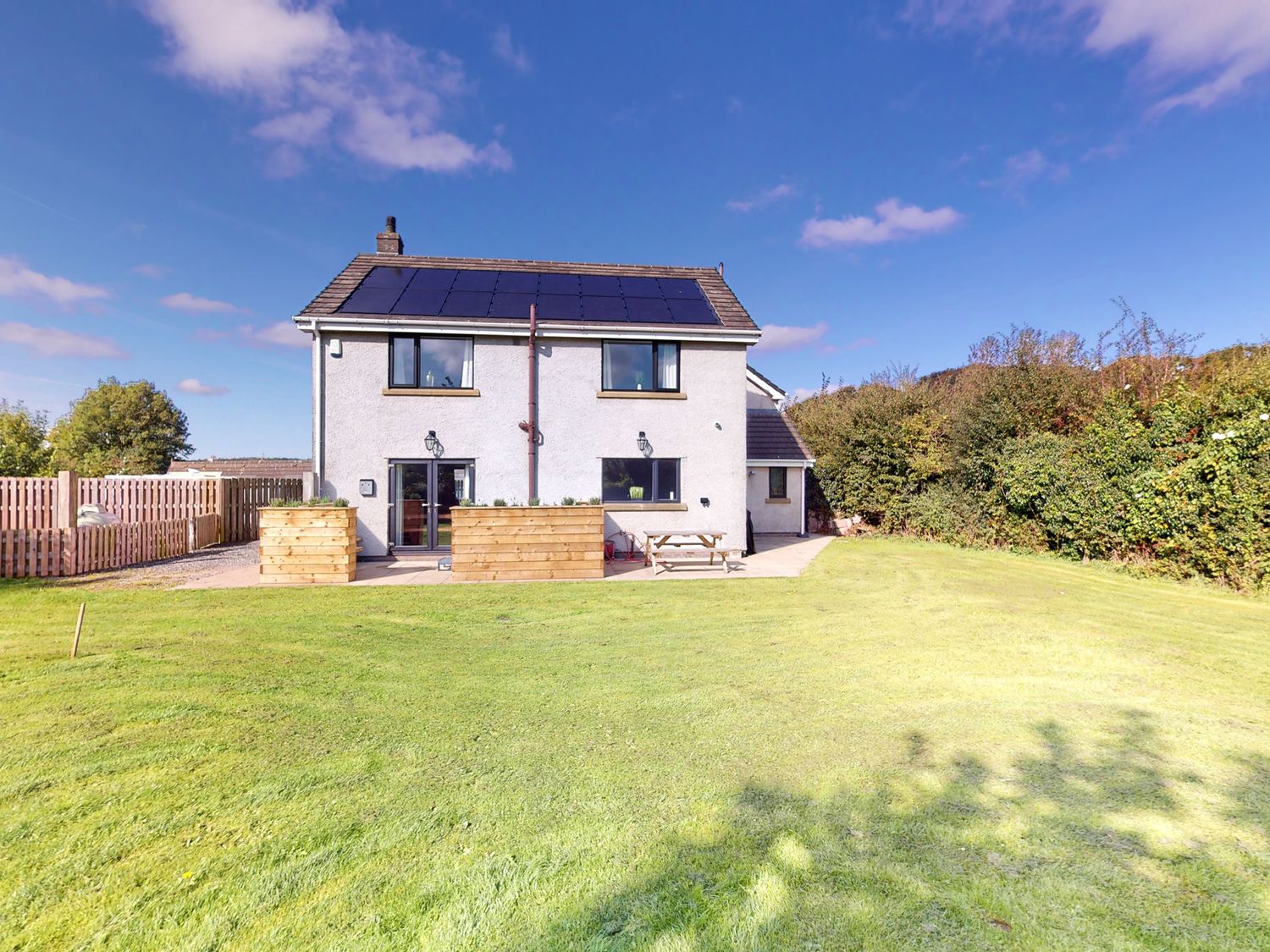 A house with garden and outdoor seating at Low Greenlands House Tewitfield