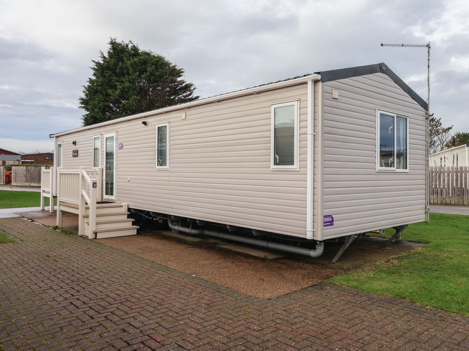 A mobile home with steps and windows at The Driftwood in High Skirlington near Skipsea