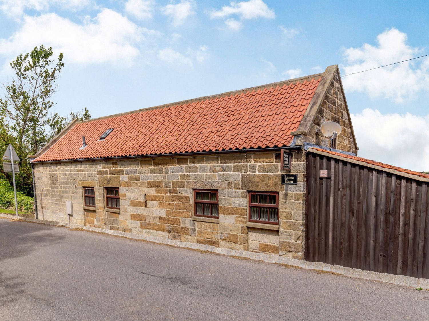 A building with a red roof and windows at Lanes Barn in Whitby