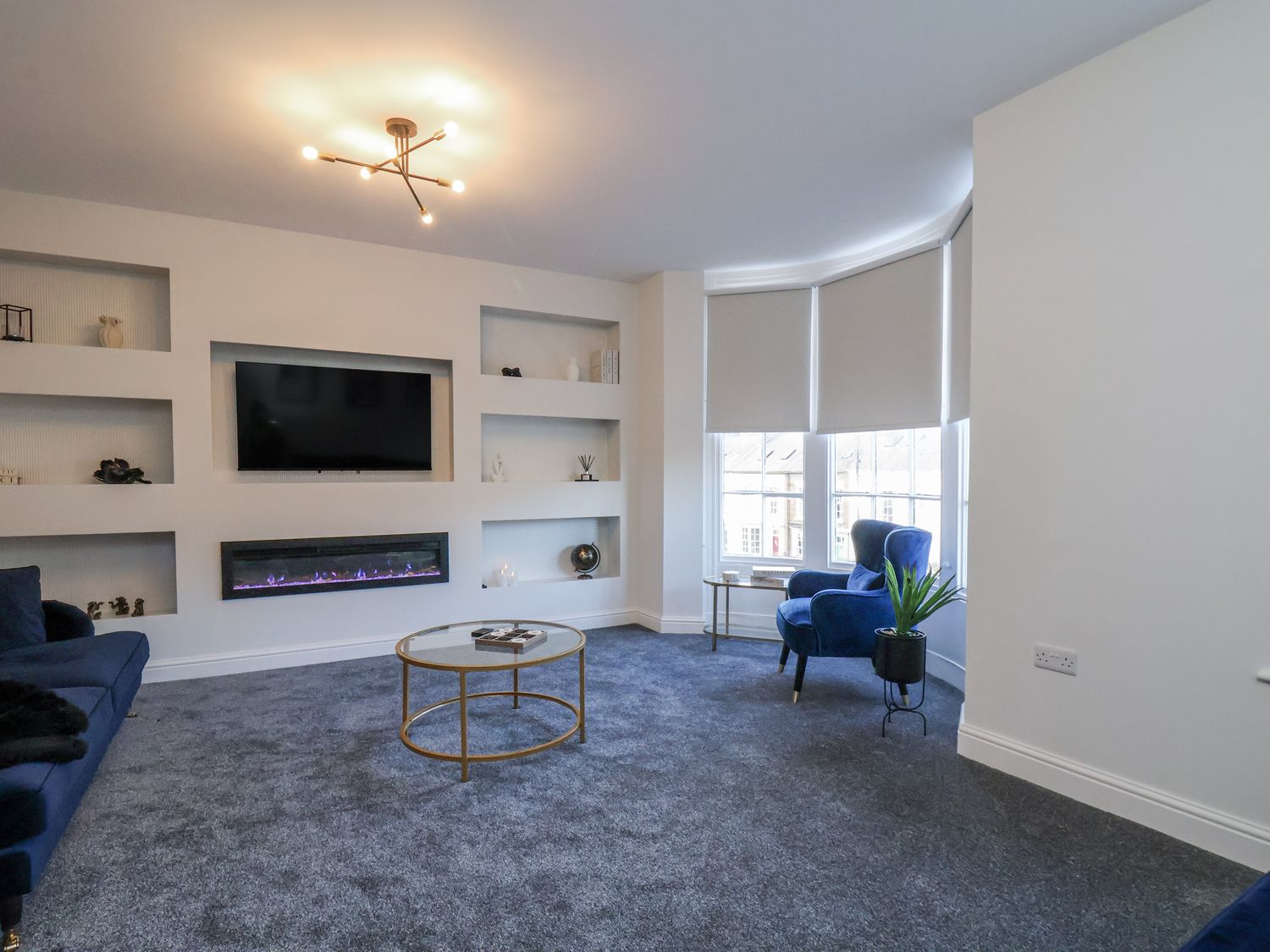 A living room with a television and electric fireplace at 2 bed in Scarborough