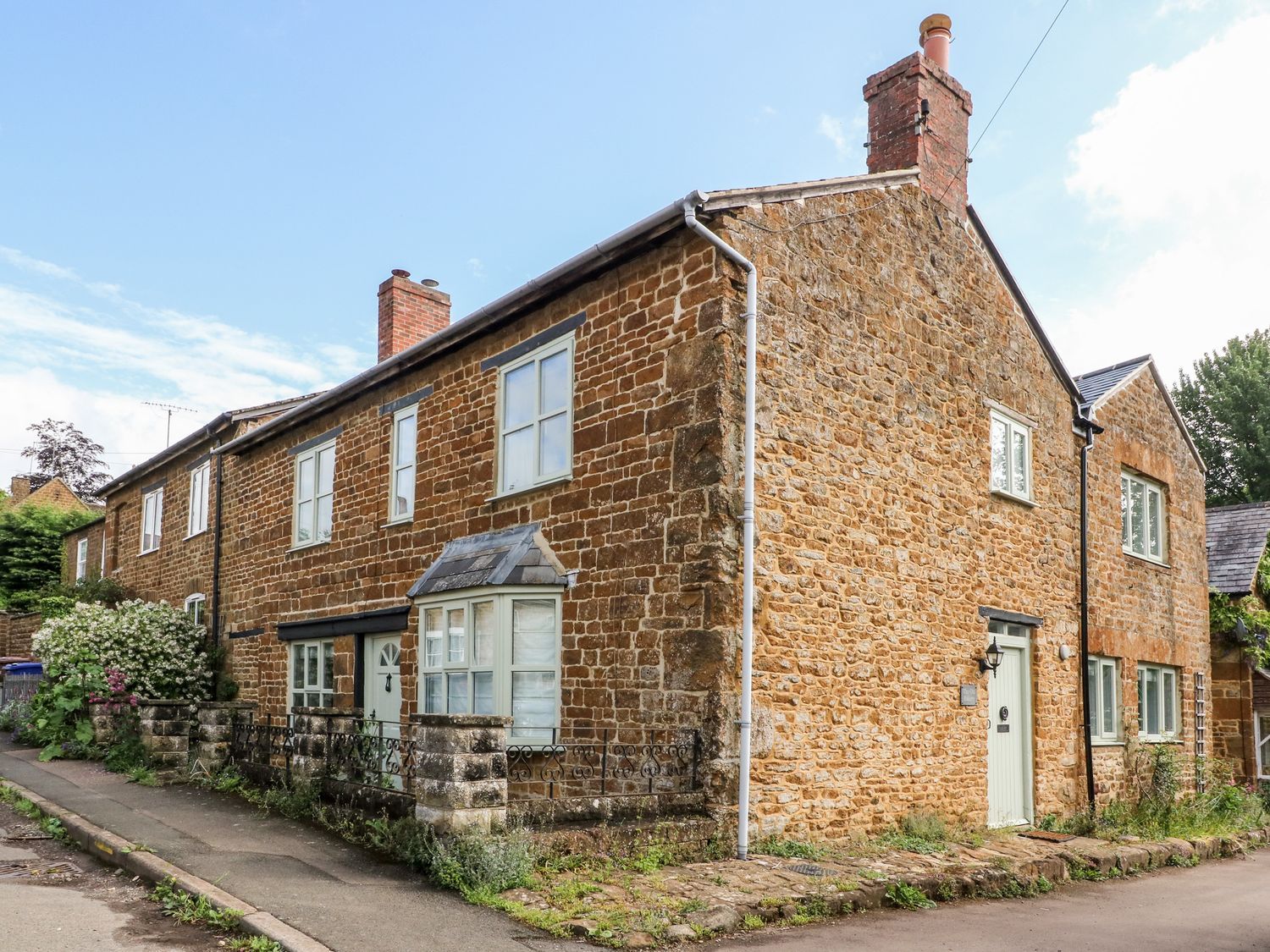 A stone house with windows and a front door at The Old Bakery in Banbury