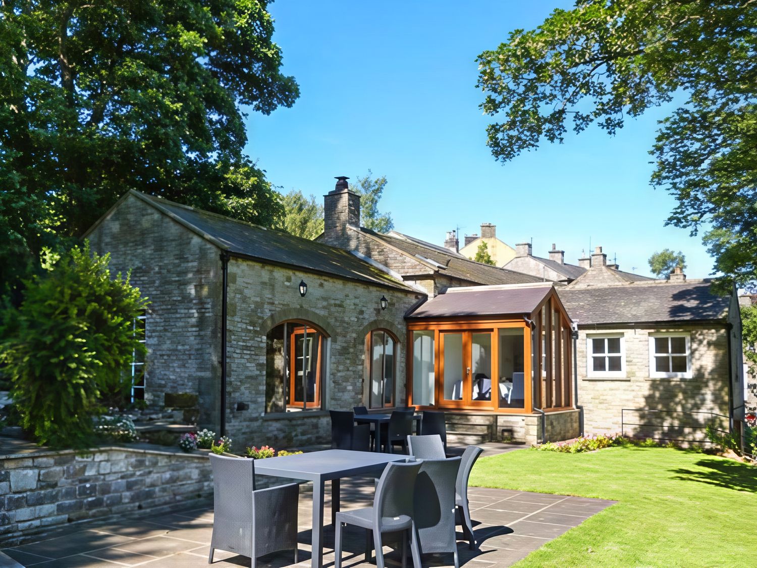 A house with a patio table and chairs in the garden at Beningborough