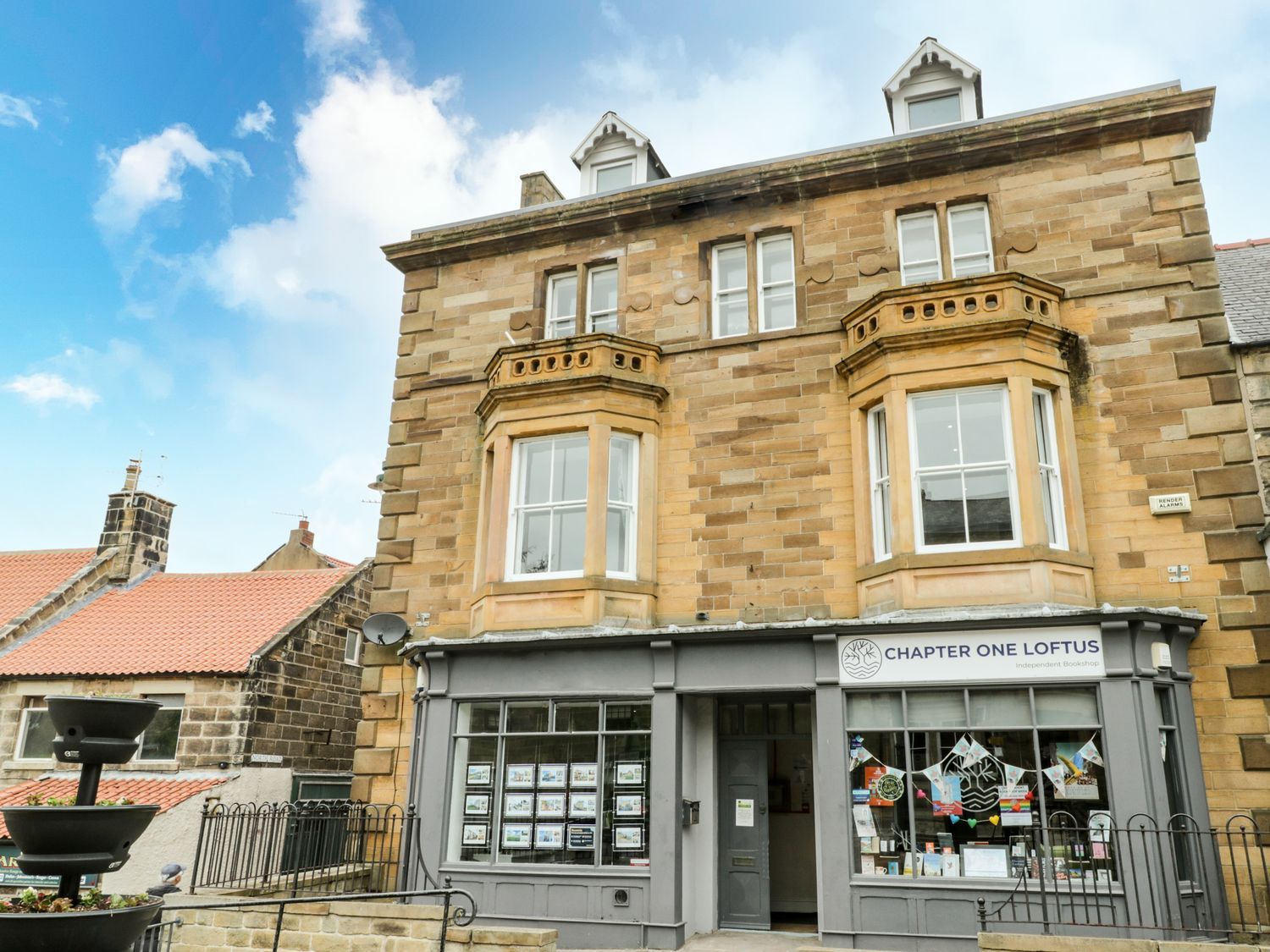 A bookstore facade with large windows and an entrance at Chapter One Loftus