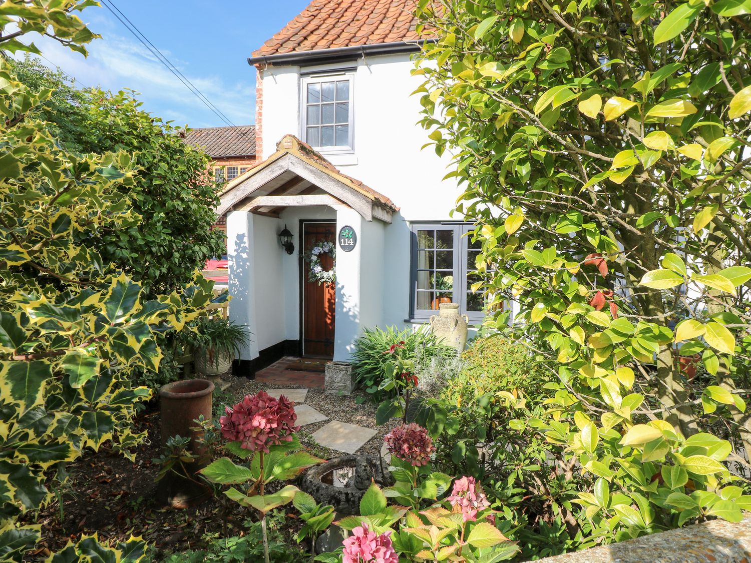 A front garden leading to the entrance at Hollyhedge Cottage in Briston