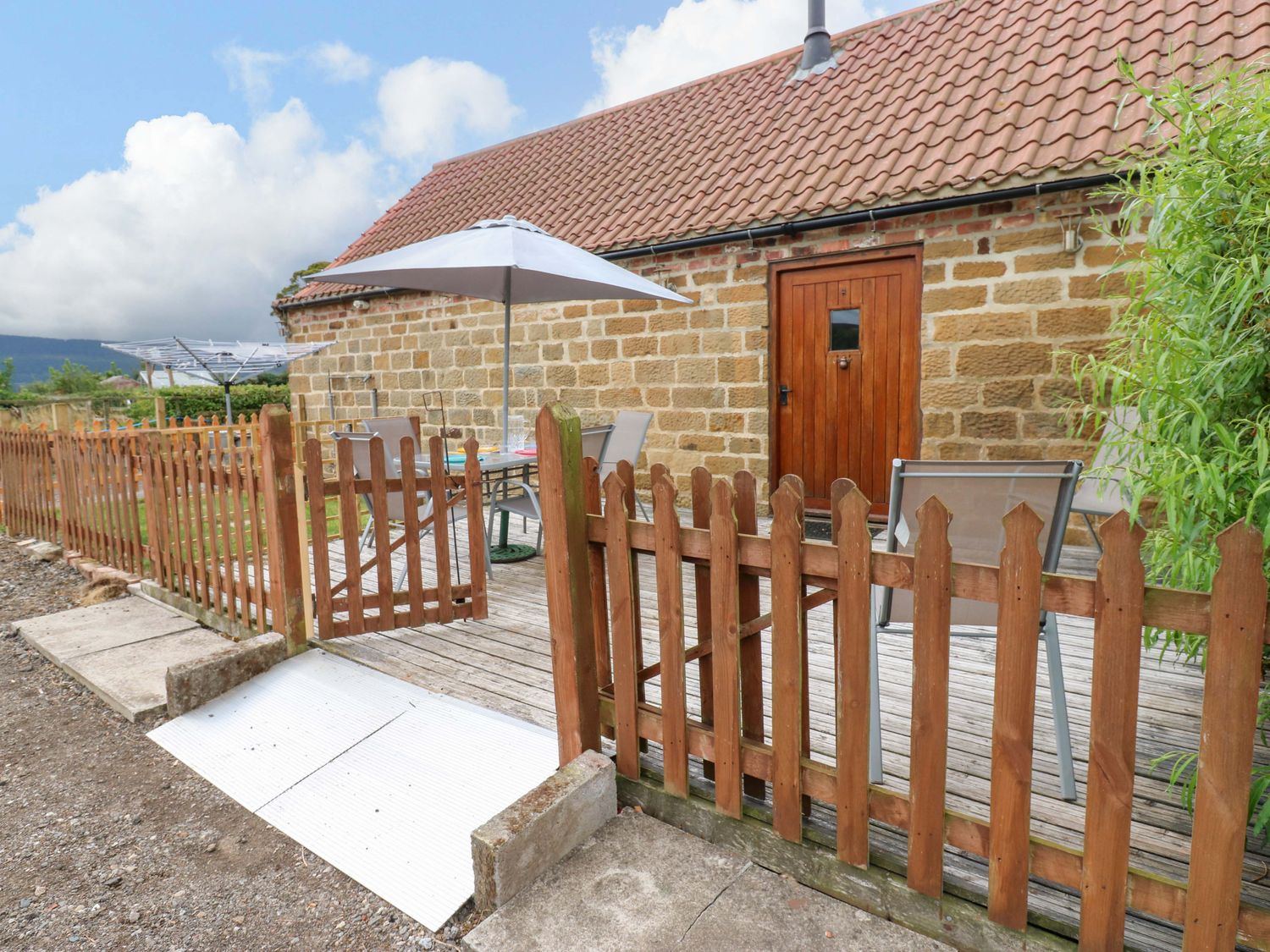 An outdoor area with a table and chairs at Pottowe Cottage in Potto near Stokesley