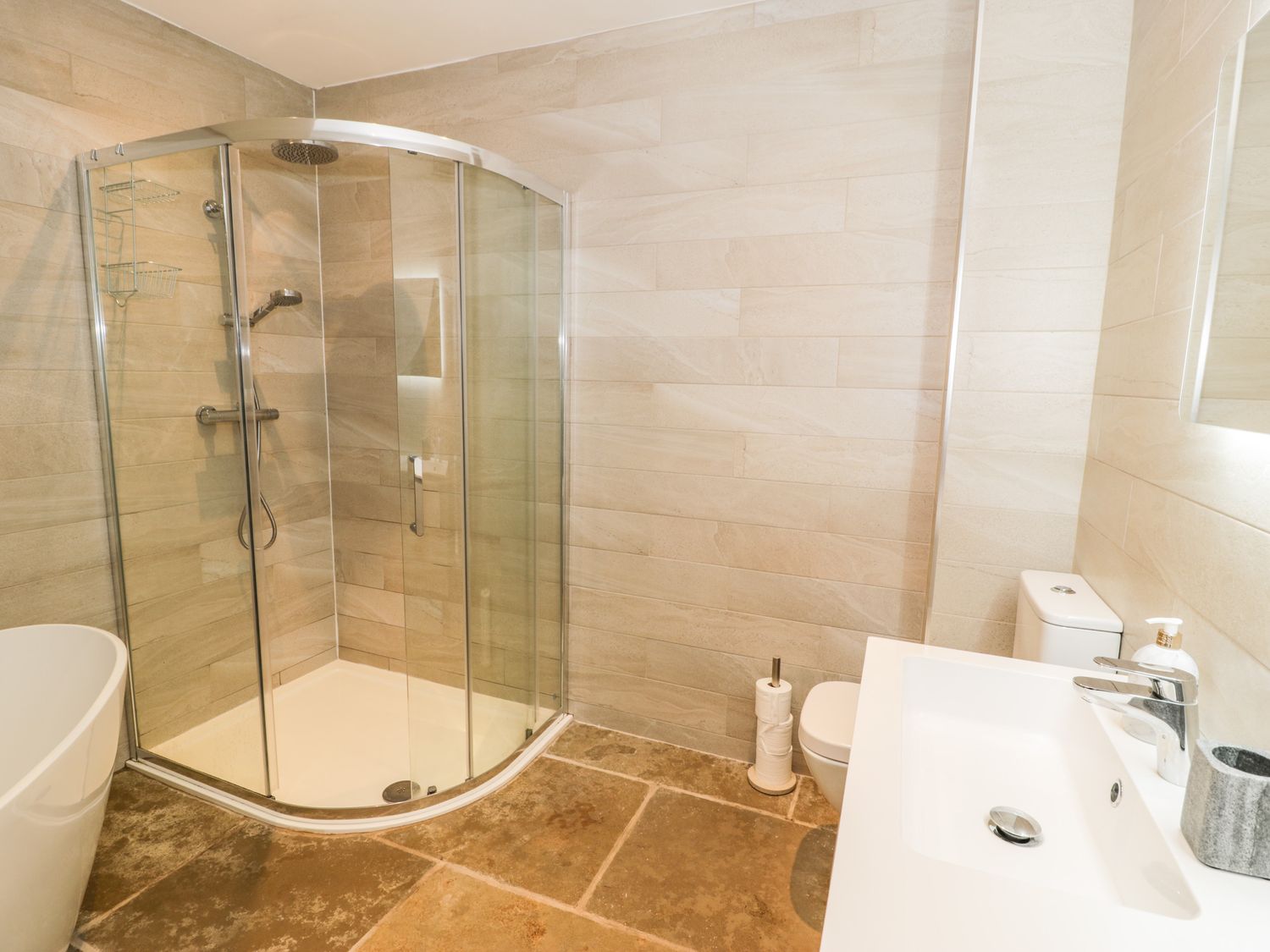A bathroom with a glass shower cubicle toilet and sink at Cae Sam in Pentraeth