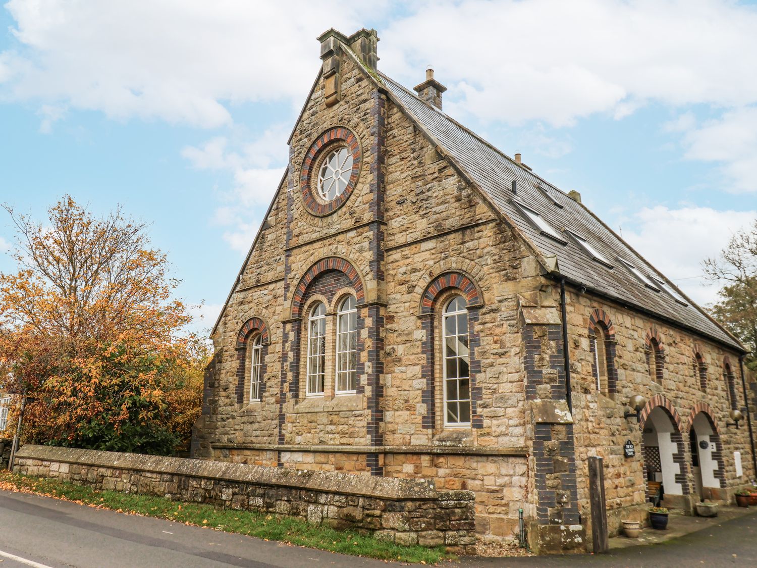 A stone building with windows and a door at 1 The Old Methodist Chapel in Rosedale Abbey