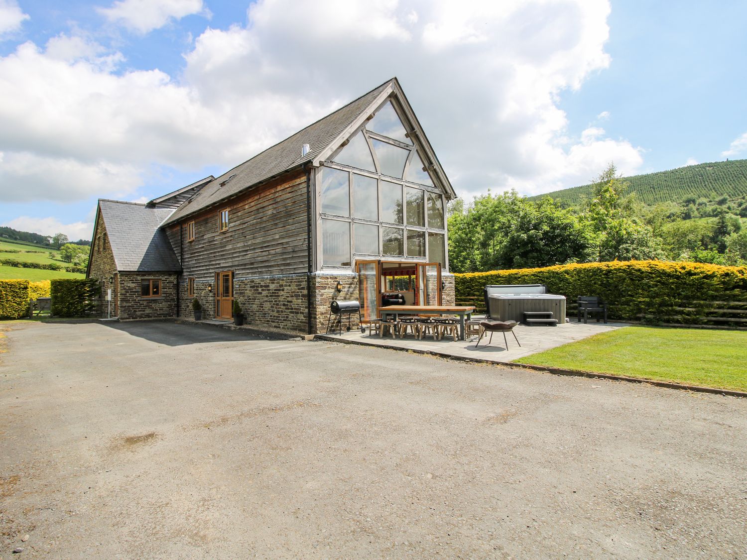 A building with a patio and outdoor furniture at The Hayloft in Bleddfa near Knighton