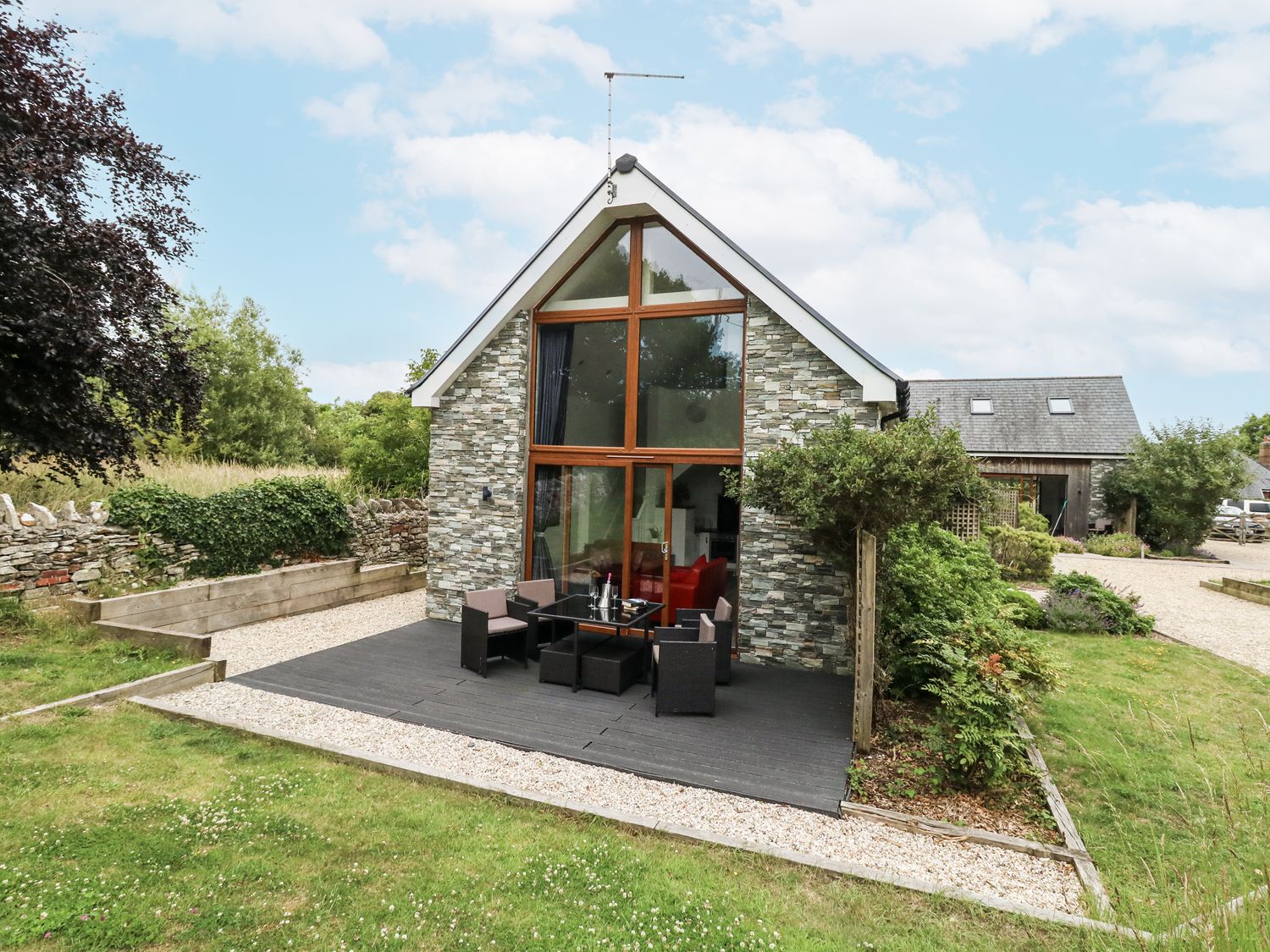 A house with outdoor seating area at Budmouth Upwey near Weymouth