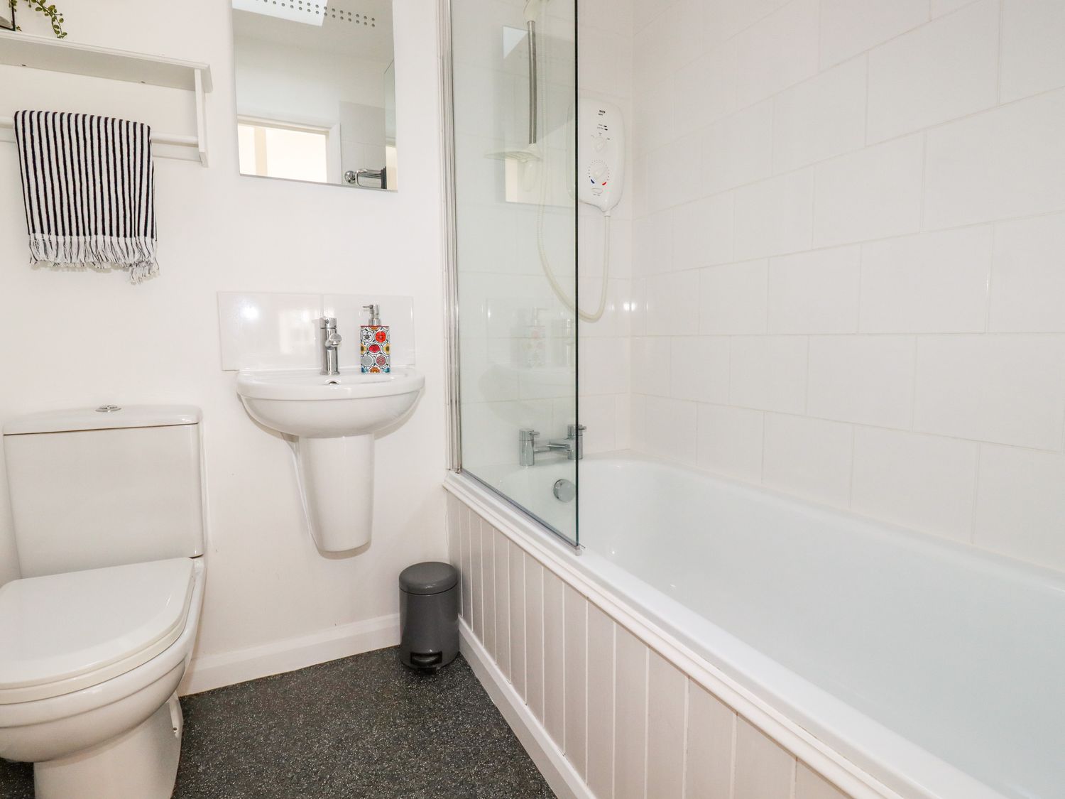 A bathroom with a toilet sink bathtub shower and towel at Slate Cottage Tredethy near Bodmin Moor
