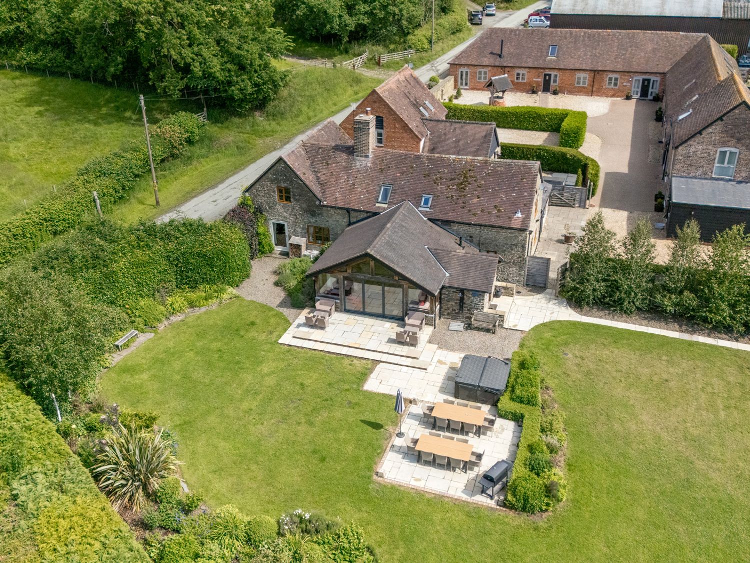 An outdoor area with a garden and patio furniture at The Old Farmhouse in Westhope