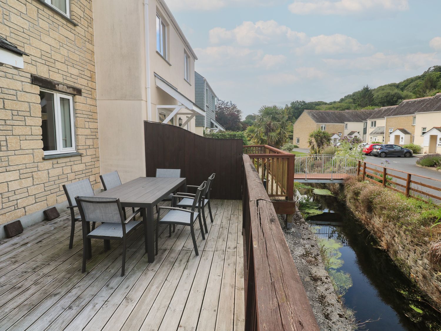 An outdoor patio with a table and chairs at Rosemary Cottage in Falmouth