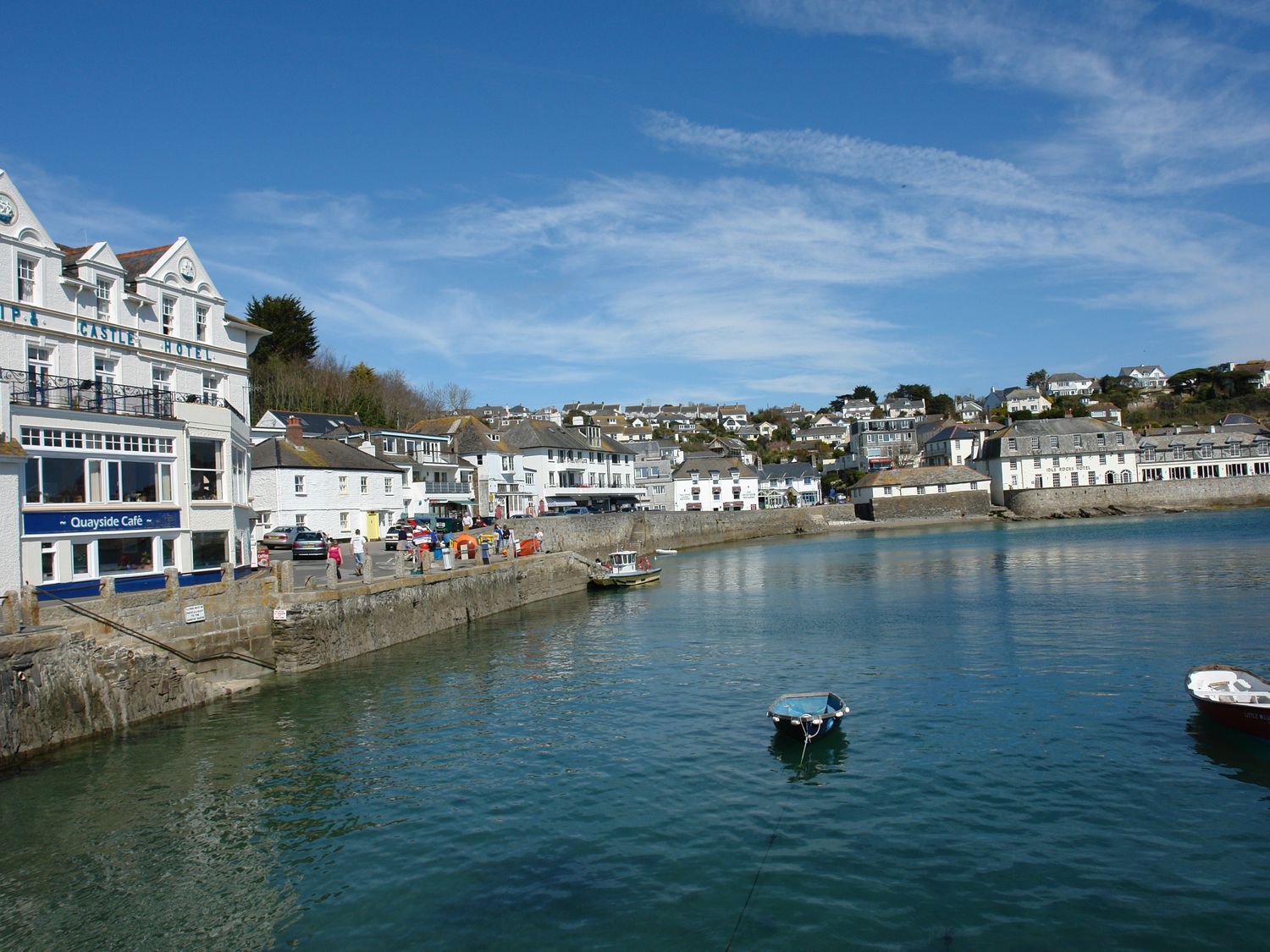 A harbor with boats on water and white buildings along the shore at Prydes Cottage in St Mawes
