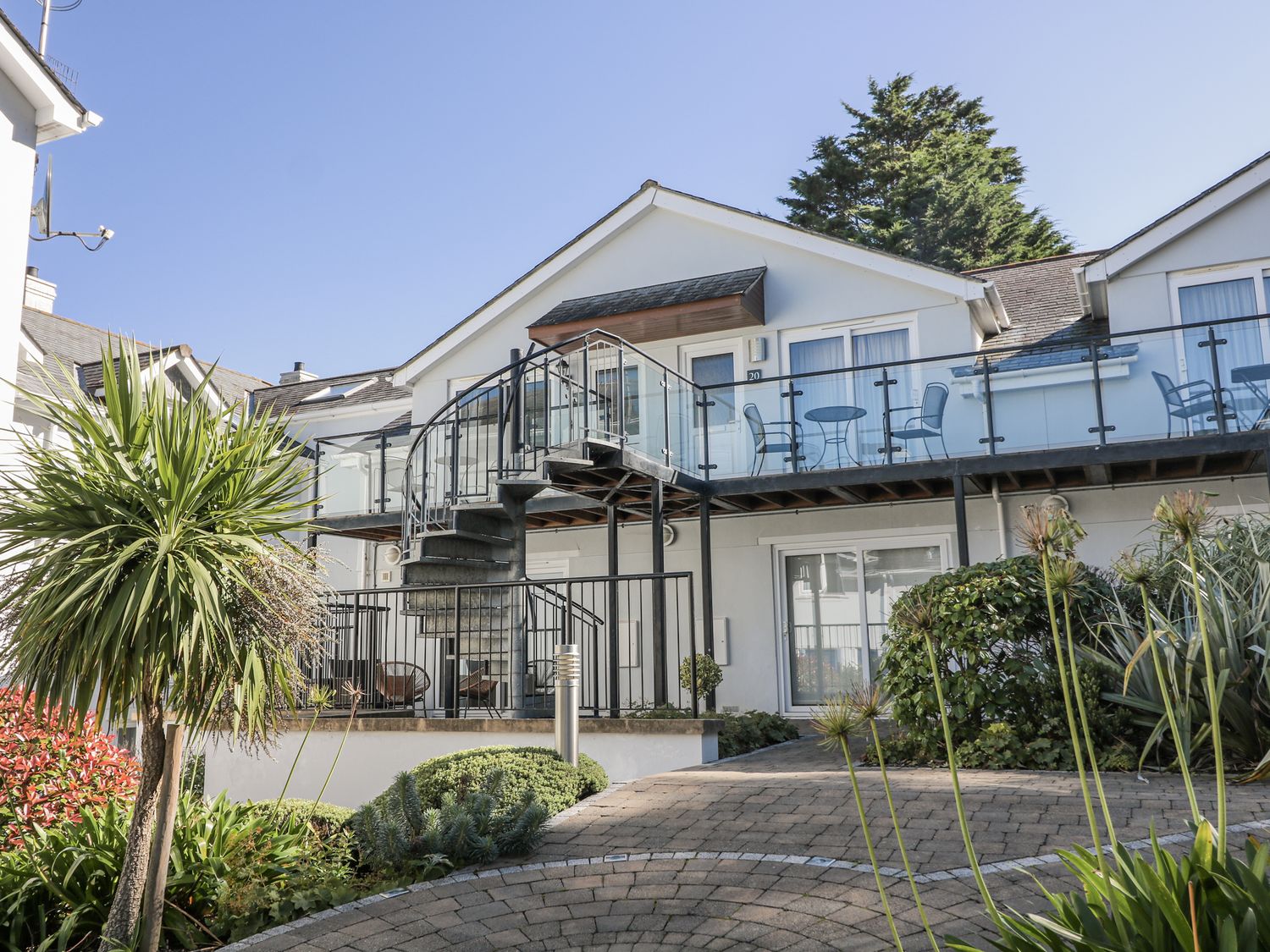 An outdoor view of a building with a staircase and balcony at 19 Bolt Head, Salcombe