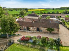 An outdoor view showing buildings and gardens at Sykes Lodge in Malton