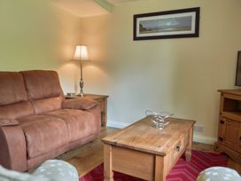 A living room with a sofa, table, lamp and decorative bowl at Daffodil Lodge Saltburn-by-the-Sea