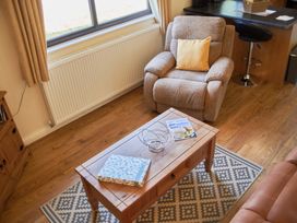 A living room with a recliner chair and coffee table at Daffodil Lodge in Saltburn-by-the-Sea