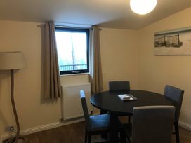 A dining room with a round table and chairs at Daffodil Lodge Saltburn-by-the-Sea