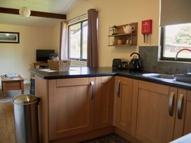 A kitchen with cabinets and appliances at Daffodil Lodge in Saltburn-by-the-Sea