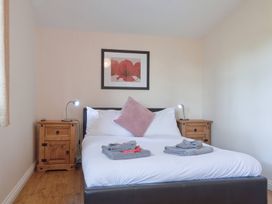 A bedroom with a bed and bedside tables at Daffodil Lodge Saltburn-by-the-Sea