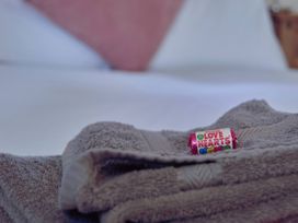 A towel with a piece of candy on it in Daffodil Lodge Saltburn-by-the-Sea