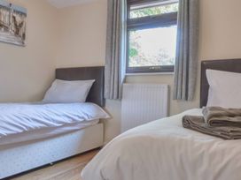 A bedroom with two beds and a window at Daffodil Lodge Saltburn-by-the-Sea