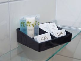 A selection of toiletries including shower gel and soap in a bathroom at Daffodil Lodge Saltburn-by-the-Sea