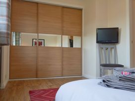 A bedroom with a sliding wardrobe and television at Daffodil Lodge Saltburn-by-the-Sea