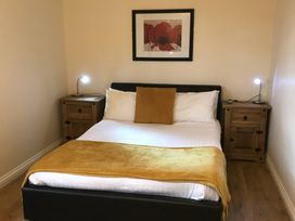 A bedroom with a bed and nightstands at Daffodil Lodge in Saltburn-by-the-Sea