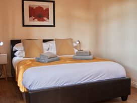 A bedroom with a bed and bedside table at Daffodil Lodge Saltburn-by-the-Sea