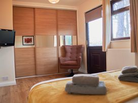 A bedroom with a bed and a chair at Daffodil Lodge Saltburn-by-the-Sea