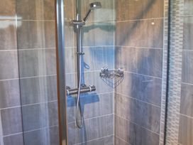 A shower with chrome fixtures at Daffodil Lodge Saltburn-by-the-Sea