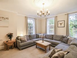 A living room with a sofa and a table at The Manor House in Scarborough