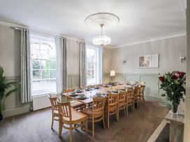 A dining room with a large table and chairs at The Manor House in Scarborough