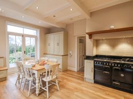 A kitchen with a table and chairs at The Manor House in Scarborough
