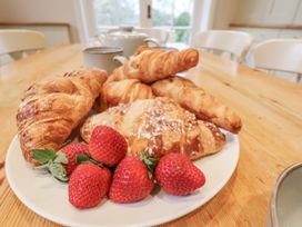 A plate of croissants and strawberries on a table at The Manor House in Scarborough