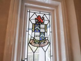 A stained glass window featuring a lion and a coat of arms at The Manor House in Scarborough