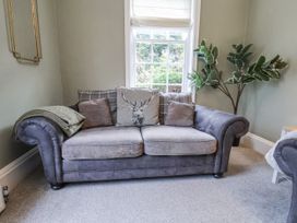 A living room with a sofa and plants at The Manor House in Scarborough