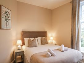A bedroom with a bed and lamps at The Manor House in Scarborough