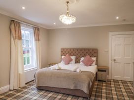 A bedroom with a bed and window at The Manor House in Scarborough