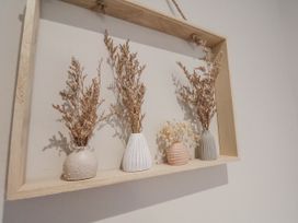 Dried flowers in vases displayed in a wooden frame