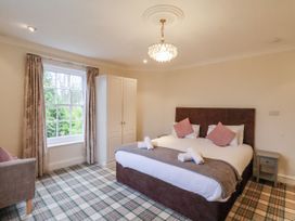 A bedroom with a bed and wardrobe at The Manor House in Scarborough