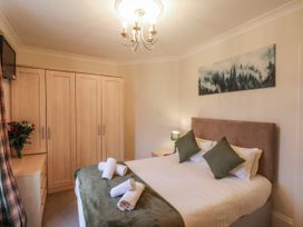 A bedroom with a bed and decorative items at The Manor House in Scarborough
