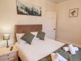 A bedroom with a bed and lamp at The Manor House Scarborough