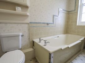 A bathroom with a bathtub and toilet at The Manor House in Scarborough