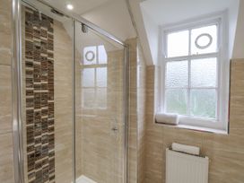 A bathroom with a shower and a window at The Manor House in Scarborough
