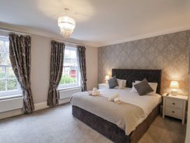 A bedroom with a bed and bedside tables at The Manor House Scarborough