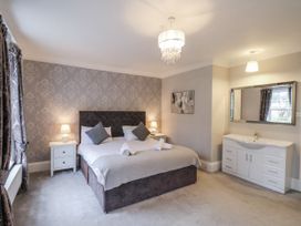 A bedroom with a bed and bedside tables at The Manor House in Scarborough
