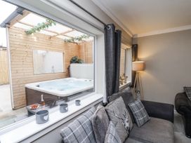 A living room with a view of a hot tub at Tennyson House in Scarborough